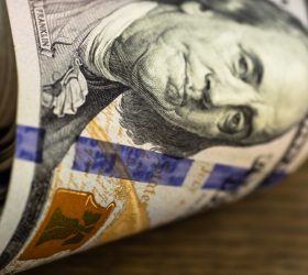 Macro shot of a 100 dollar. Dollars Closeup Concept. American Dollars Cash Money. One Hundred Dollar Banknotes. Hundred Bucks. Benjamin Franklin's portrait.