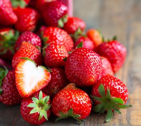Fresh strawberries on wooden table.